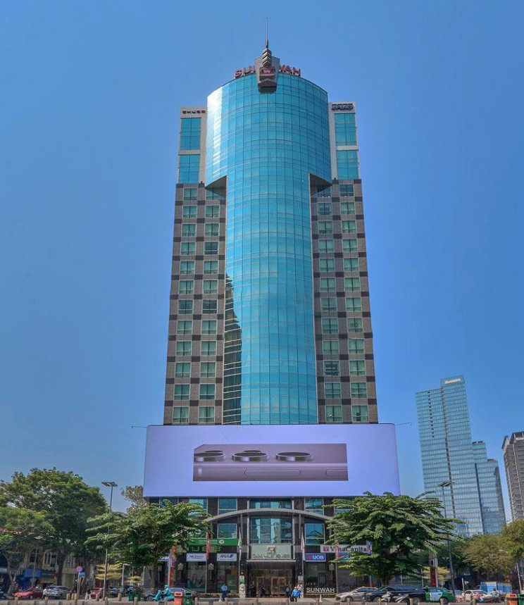 Chính diện tòa tháp Sun Wah Tower với màn hình LED lớn và tháp phong thủy